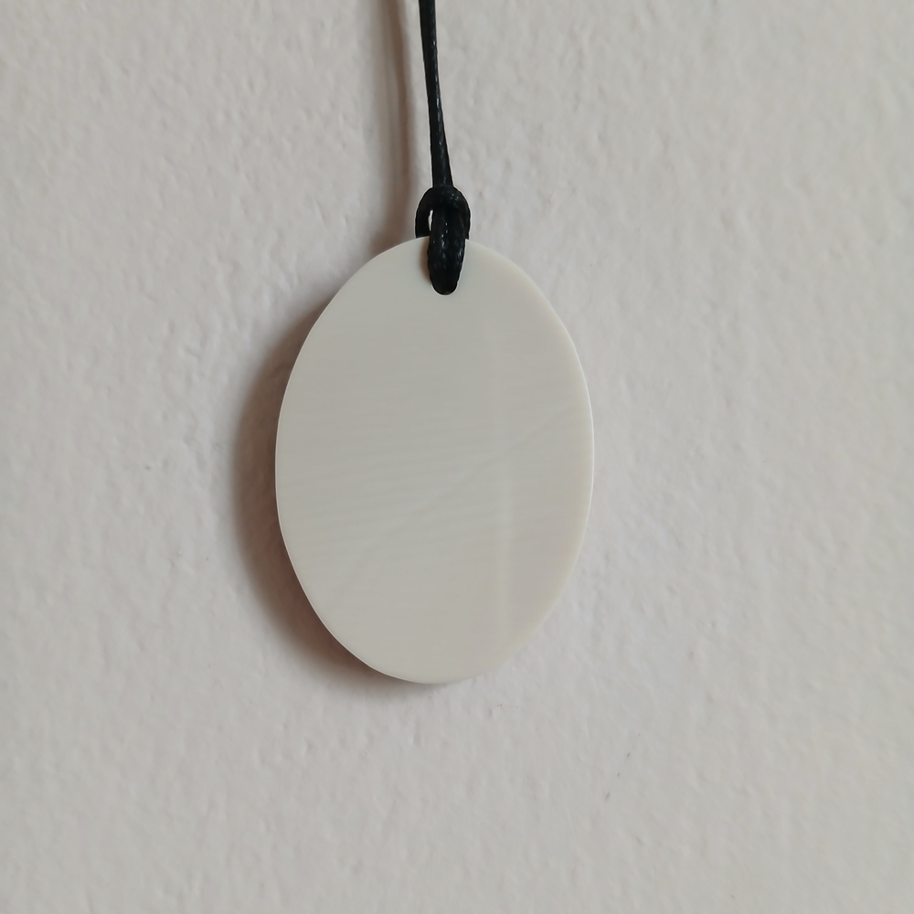 A mammoth tusk pendant in a hornbeam wood frame.